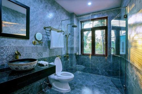 a bathroom with a sink and a toilet and a shower at Friendly Villa Hoian in Hoi An