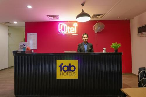 a woman is standing at a reception desk at Via Chattarpur Enclave - Opposite Tivoli Garden in New Delhi