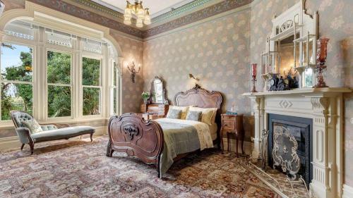 a bedroom with a bed and a fireplace at Mt Eden Victorian Villa in Auckland