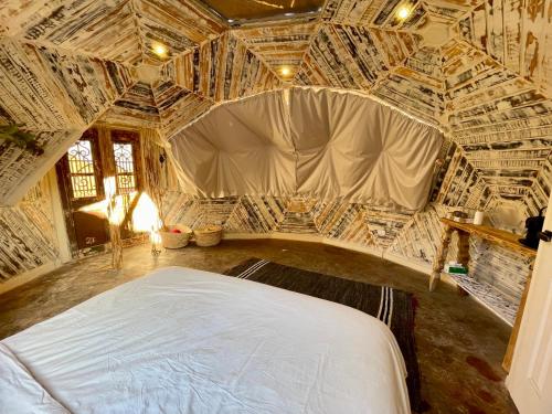a bedroom with a large bed in a room at Mannam desert dome in Dahab