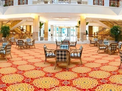 黄山市Huizhou Wanyun Holiday Hotel的大堂设有带桌椅的用餐区。