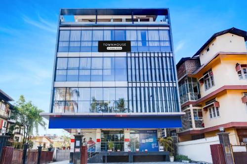 a tall building with a sign on it at Super Townhouse Bhangagarh Bus Terminal Formerly The Rudra Inn in Guwahati