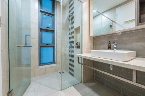 a bathroom with a sink and a shower at The Robertson Bukit Bintang by Centurypro in Kuala Lumpur