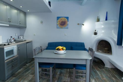 a kitchen with a table with a bowl of fruit on it at Castelo Beach Hotel in Panteli