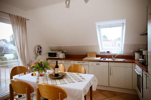 a kitchen with a table with a white table cloth at FeWo Machedanz am Hafen Timmendorfer Strand OT Niendorf in Timmendorfer Strand