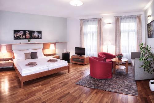 a bedroom with a bed and a living room at Penzion Baltazar Mikulov in Mikulov