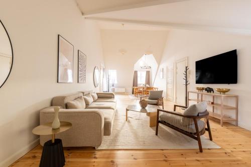 a living room with a couch and a tv at Light-Filled 5BR Home Near Tivoli & Strøget for 12 in Copenhagen
