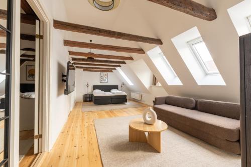 a living room with a couch and a bed at Light-Filled 5BR Home Near Tivoli & Strøget for 12 in Copenhagen