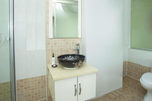 a bathroom with a sink and a toilet and a bowl at Super 8 Hotel Chengde Imperial Summer Resort in Chengde