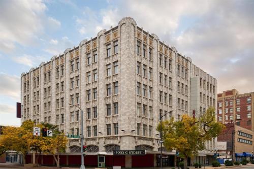a large stone building on a city street at Hampton Inn by Hilton Lincoln Downtown in Lincoln