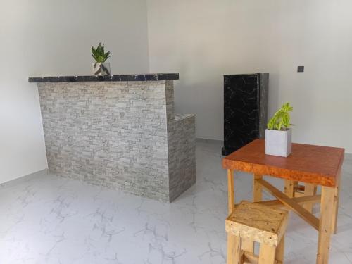 a brick fireplace with two potted plants on top of it at Nikita Homestay in Kosgoda