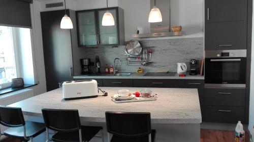 a kitchen with a counter with a laptop on it at Duplex "Harmony" in Spa