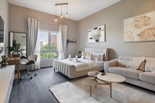 a living room with a couch and a table at Luxury studio in Discovery Gardens near metro in Dubai