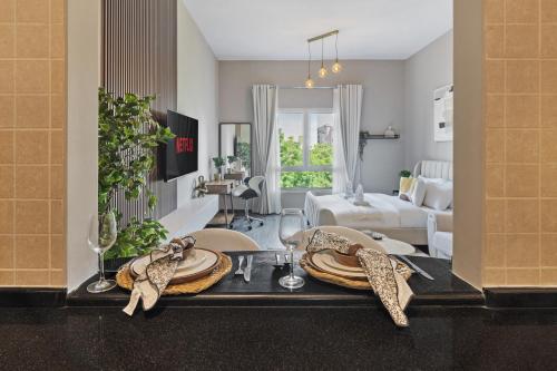 a living room with a table with plates on it at Luxury studio in Discovery Gardens near metro in Dubai