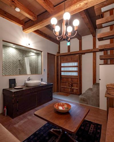 a bathroom with a sink and a wooden table at The Bath and Bed Tateyama in Toyama