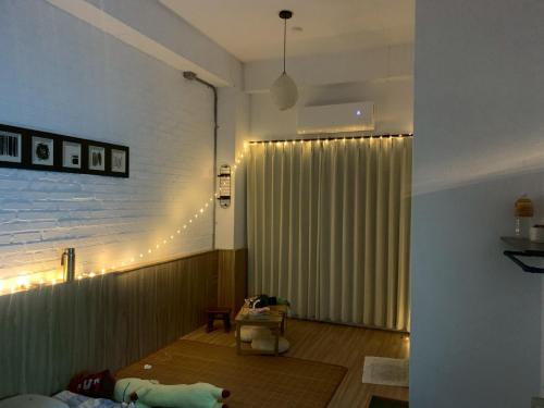 a living room with a large window with a curtain at 陌野輕旅民宿 in Xiulin