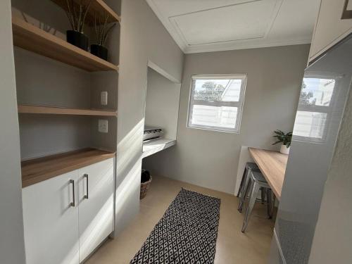 a small kitchen with a desk and a window at The Tidal Court in Sea Vista