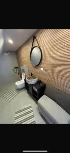 a room with a bed and a desk and a lamp at Cabana Ana in Feleacu