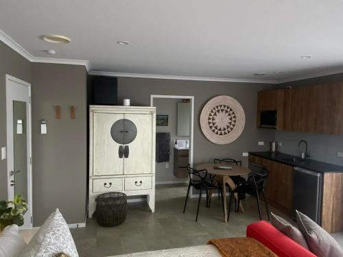a living room with a kitchen and a dining room at Escape in New Plymouth