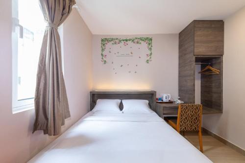Un pat sau paturi într-o cameră la Sunlight Hotel Kulai