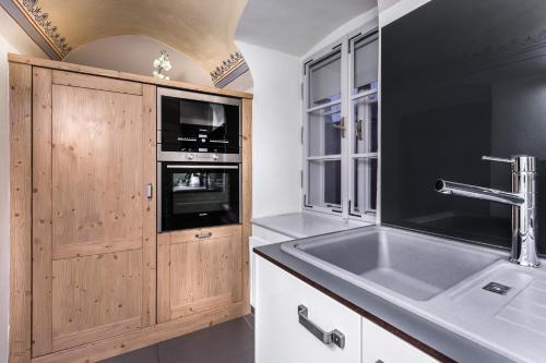 a kitchen with a sink and a microwave at Pension Athanor in Český Krumlov