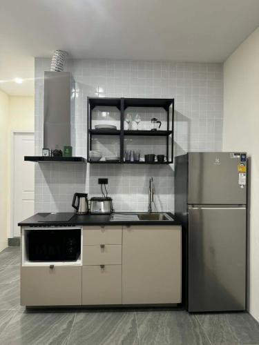 a kitchen with a sink and a refrigerator at Scandi Haus near ChinaTown in Bangkok