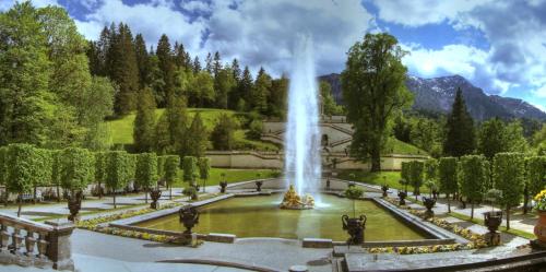 a fountain in the middle of a park at Mammhofer Suite & Breakfast in Oberammergau