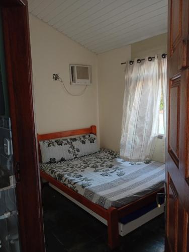 Ένα ή περισσότερα κρεβάτια σε δωμάτιο στο Pousada Descanse & Curta