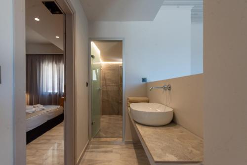a bathroom with a white tub and a sink at Villa Dorothea in Georgioupoli