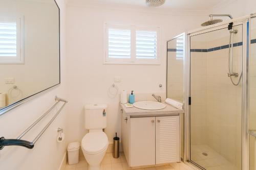 a bathroom with a shower and a toilet and a sink at Sunset Spa Escape - Ocean Views in Perth