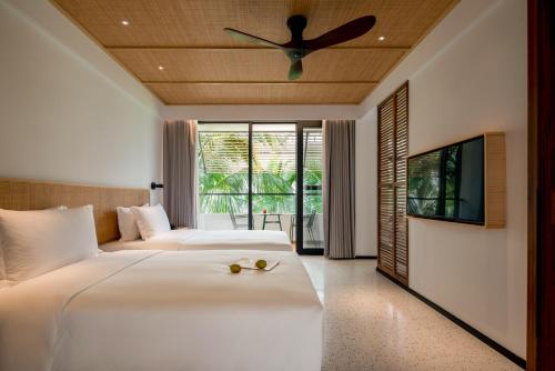 Ένα ή περισσότερα κρεβάτια σε δωμάτιο στο Jinghong Golan Garden Hotel in Xishuangbanna