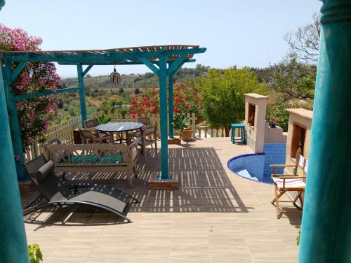 a patio with a gazebo and a table and chairs at Finca Sencilla in Mijas