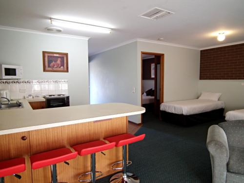 a hotel room with a bar and a bed at Cobram Barooga Golf Resort in Barooga