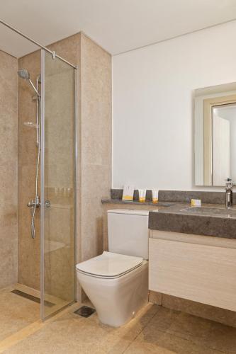 a bathroom with a toilet and a shower and a sink at VESTA - El Gouna Residence in Hurghada
