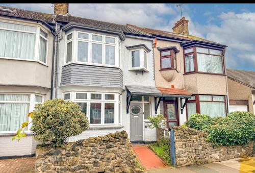 a large white house with a stone wall at Welcome to Northview House Stylish 4 Bedroom Home in Southend by Jesswood Properties Contractors Corporates Relocation Stays Long Stays Welcome in Southend-on-Sea