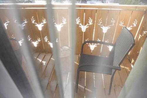 a black chair on a deck with antlers on the fence at Wiślański Renifer in Wisła