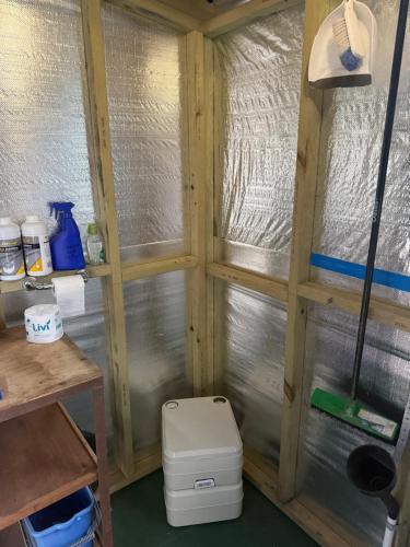 a small bathroom with two windows and a toilet at Onsite van in Medlow Bath in Medlow Bath