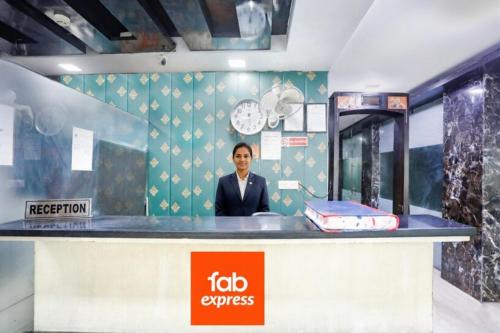 a man standing behind a counter in a room at Via Lotus Palace in New Delhi