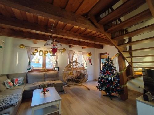 a living room with a christmas tree in it at Wellness Chata Tatry in Veľká Lomnica