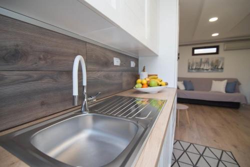 a kitchen with a sink and a bowl of fruit at Andrej studio A2 in Veli Lošinj