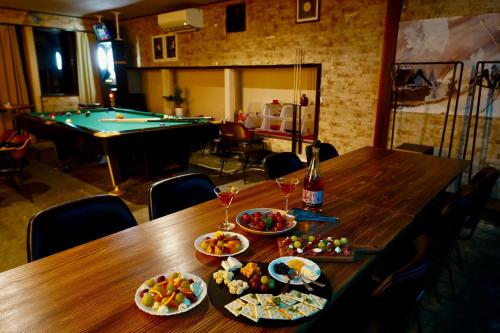 a table with food and drinks and a pool table at Max 29ppl, Entire Villa, Darts & Billiards & Karaoke, 5 Parking, Near Ski Resort in Yuzawa