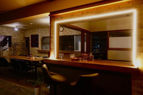 a kitchen with a bar with a table and chairs at Max 29ppl, Entire Villa, Darts & Billiards & Karaoke, 5 Parking, Near Ski Resort in Yuzawa