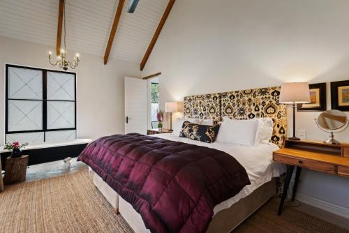 a bedroom with a king sized bed and a table at Hemyock Farm Moon Cottage in Nottingham Road