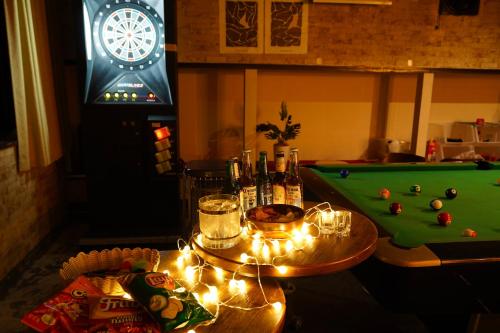 a living room with a pool table with lights and a pool table at Max 29ppl, Entire Villa, Darts & Billiards & Karaoke, 5 Parking, Near Ski Resort in Yuzawa