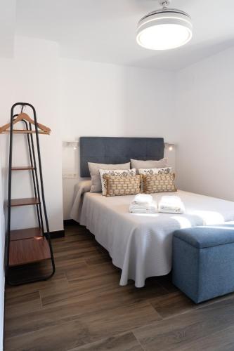 a bedroom with a bed with a ladder and a chair at La Carrera 7 - La Catedral - Parking sujeto a disponibilidad in Jaén