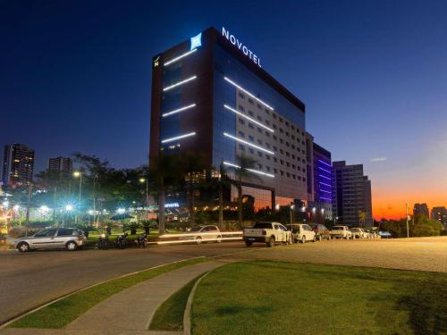 a large building with a sign on it at night at Novotel Sorocaba in Sorocaba