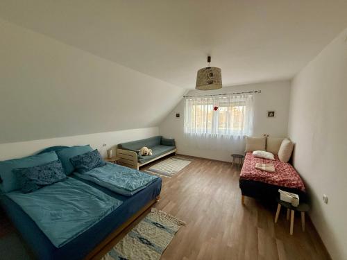 a living room with a bed and a couch at Chill & Pool Retreat Almádi in Balatonalmádi