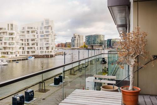 a balcony with a view of a river and buildings at Water Front View - Prime Apartment in Copenhagen