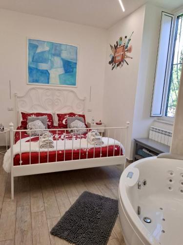 a bedroom with a red and white bed and a bath tub at The Secret Garden in Salerno