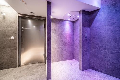 a purple bathroom with a shower with purple tiles at Apartment Cumbre Alpe d'Huez - by EMERALD STAY in LʼHuez